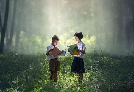 Asian students reading books in Thailand countryside, Thailand, Asiaの写真素材