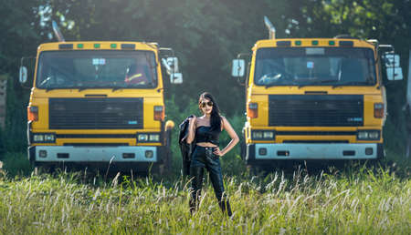 Asian model posing with truck in an outdoor environmentの写真素材