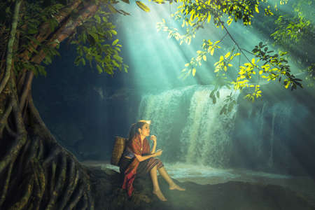 Asian woman at the waterfall, Thailandの写真素材