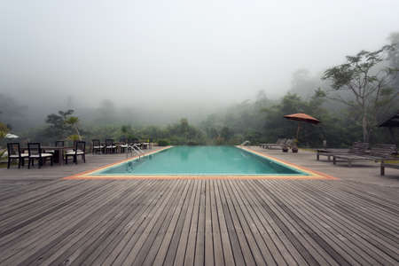 Nice swimming pool outdoors with mist in the morningの写真素材