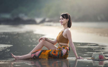Pretty woman relaxing at tropical beach. Remote tropical beaches and countries. Travel concept.の写真素材