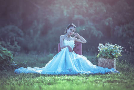 Asian bride with wedding dress in a parkの写真素材