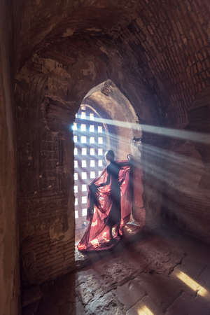 Novice monk standing in ancient temple,Bagan Myanmarの写真素材