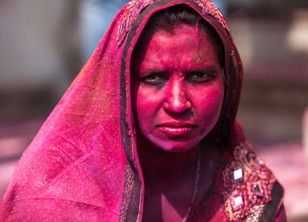 MATHURA, INDIA - Feburary 25,2018: Indian Hindu revellers smeared with colour dance during the Holi festival celebration in Mathura, Indiaのeditorial素材