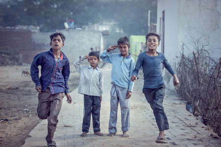 MATHURA, INDIA - Feburary 23,2018: Group of boisterous Indian children running for photograph in Agra, Uttar Pradesh, India.のeditorial素材
