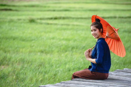 Beautiful rural Asian woman in traditional costume.の写真素材