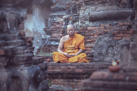 Asia monk vipassana for meditation at old temple of Thailand.の写真素材