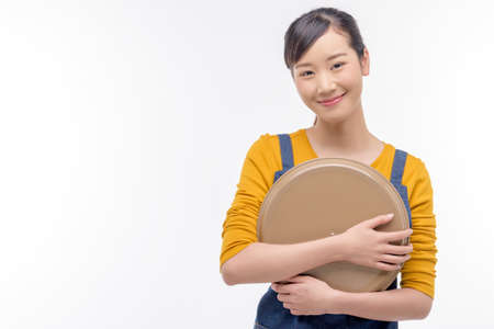 Young attractive woman holding an empty tray isolated on white background.の写真素材