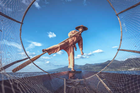 Intha fishermen working in the morning. Location of Inle lake, Myanmar.の写真素材