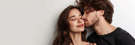 Panoramic shot of young man passionately kissing brunette woman with closed eyes isolated on whiteの素材