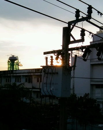 New day on the roof top view of the electric light post and elevated water tank.の素材
