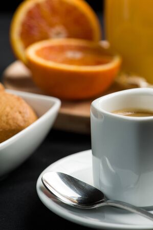 Espresso cup with orange juice on the backgroundの写真素材