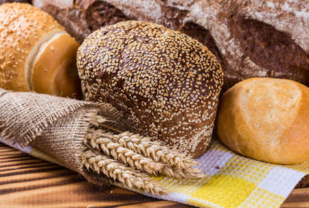 assortment of baked bread on wood table