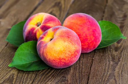 fresh peaches on wood backgroundの写真素材