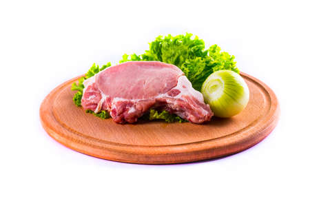 Fresh meat and vegetables on kitchen boardの写真素材
