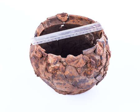 Prehistoric iron pot on a white backgroundの写真素材
