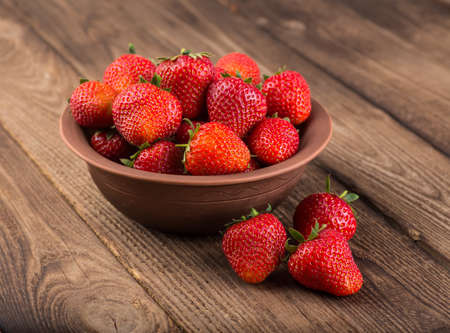 Ripe red strawberries on wooden tableの写真素材