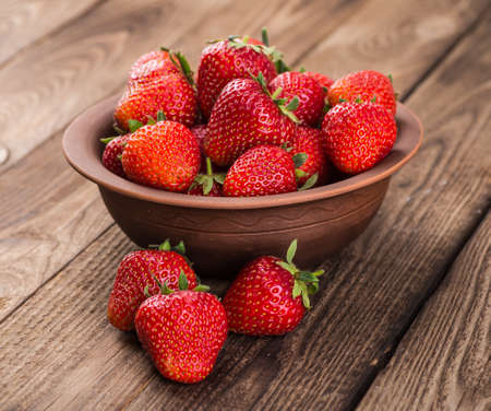 Ripe red strawberries on wooden tableの写真素材
