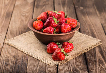 Ripe red strawberries on wooden tableの写真素材