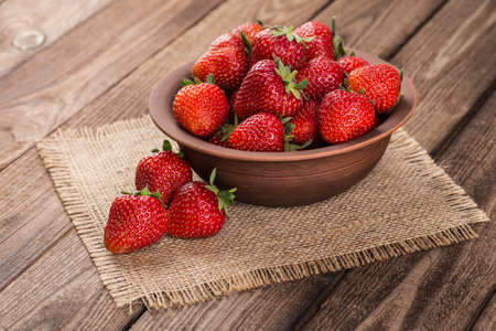 Ripe red strawberries on wooden tableの写真素材