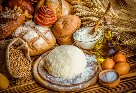 fresh bread and wheat on the woodenの写真素材