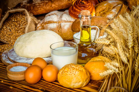 fresh bread and wheat on the woodenの写真素材
