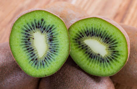 Fresh kiwis on wooden groundの写真素材
