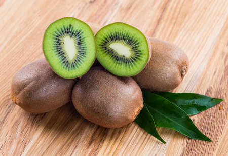 Kiwi fruit on brown wooden backgroundの写真素材