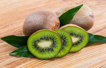 Kiwi fruit on brown wooden backgroundの写真素材