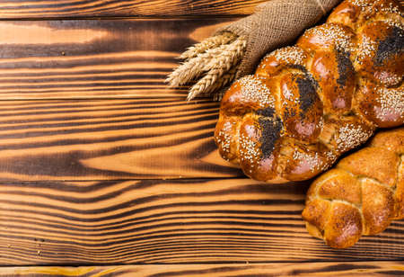 Assortment of baked bread on wooden table backgroundの写真素材