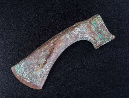 Prehistoric bronze ax, the ancients, isolated on black backgroundの写真素材