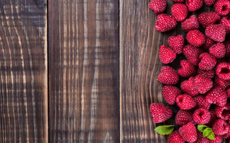 raspberries in a bowl on a wooden background