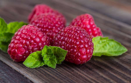 raspberries in a bowl on a wooden background