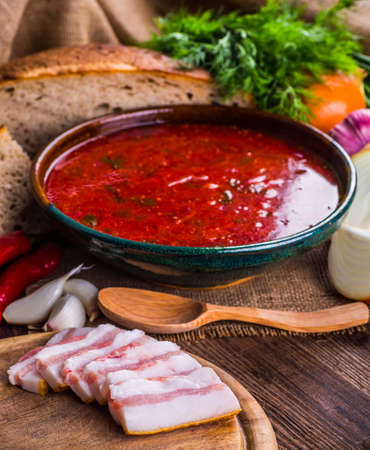 Ukrainian beetroot soup - borscht, on napkin, on wooden background
