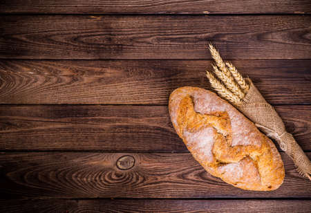 Assortment of baked bread on wooden table backgroundの写真素材