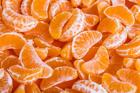 Tangerine segments, orange background textureの写真素材