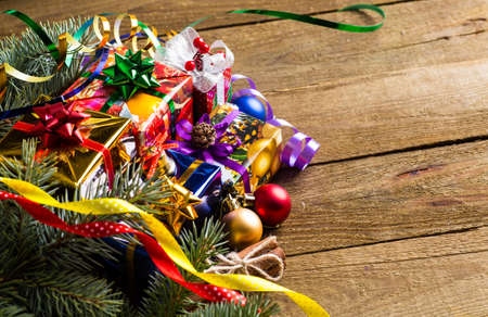 Christmas presents with christmas decorations on wooden background.