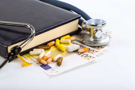 Stethoscope, pills and bottles on color background. medicine conceptの写真素材