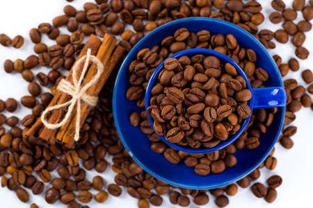 Cup of coffee and beans with delicious macaroon on a white background.の写真素材