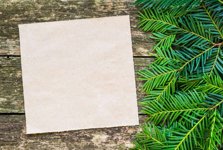 Christmas fir tree with decoration on a wooden boardの写真素材
