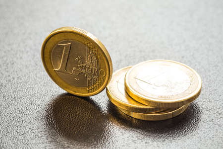 Euro coins. One Euro coin on the foreground.