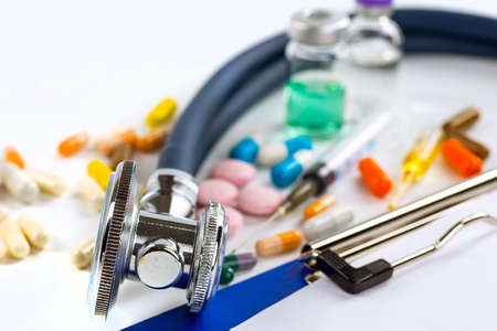 Stethoscope, pills and bottles on color background. medicine conceptの写真素材