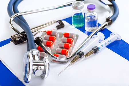 Stethoscope, pills and bottles on color background. medicine conceptの写真素材