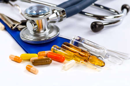 Stethoscope, pills and bottles on color background. medicine conceptの写真素材