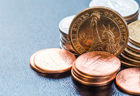 dollar coins stack on blackの写真素材