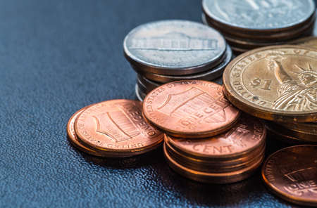dollar coins stack on blackの写真素材