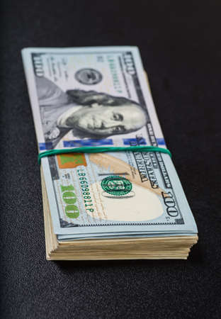 Stack of one hundred dollar bills close-up.