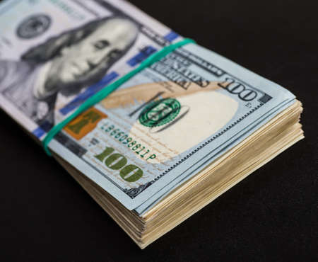 Money roll with US dollars. Selective focus.の写真素材