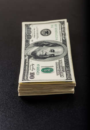 Money roll with US dollars. Selective focus.