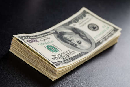 Stack of one hundred dollar bills close-up.の写真素材